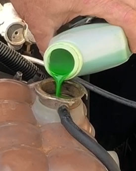 Pouring corrosion inhibitor into coolant reservoir