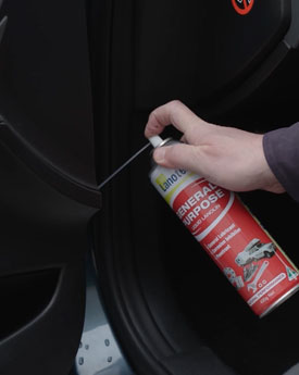 Screwdriver loosening spring clips on struts